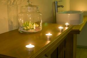 Badezimmer im Le Peninsula Bay Beach Resort & Spa mit Kerzen und Glasvase