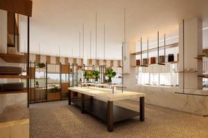 Innenbereich des NissiBlu Beach Resort mit modernem Design, Marmortischen und hängenden Pflanzen.