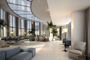 Innenansicht der Lobby des NissiBlu Beach Resort mit großen Fenstern und modernen Möbeln.