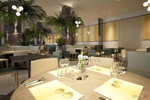 Innenansicht des Restaurants im NissiBlu Beach Resort mit Tischen, Stühlen und Pflanzen.