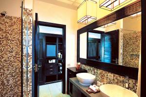 Badezimmer im Bahari Zanzibar Hotel mit zwei Waschbecken und einem großen Spiegel.