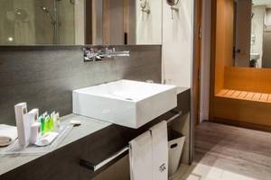 Badezimmer im Barcelona Catedral Hotel mit einer weißen Wanne, Handtüchern und Toilettenartikeln.