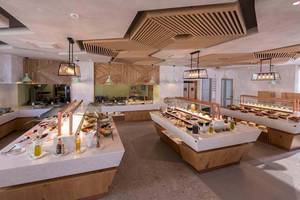 Innenansicht des Restaurants im Cactus Mare Hotel mit vielen Speisen auf Marmortheken.