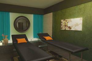 Massagesalon im Melia Marina Varadero mit zwei schwarzen Liegen, runden Spiegeln und grünen Wänden.