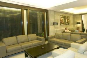 Loungebereich im D'Andrea Mare Beach Hotel mit mehreren Personen, die auf Sofas sitzen.
