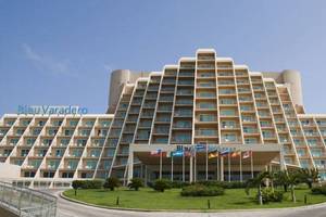 Außenansicht des Blau Varadero Hotels mit vielen Fenstern und Flaggen vor dem Gebäude