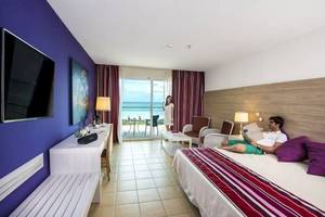 Mann im Hotelzimmer von Blau Varadero liest ein Buch, Blick auf den Ozean