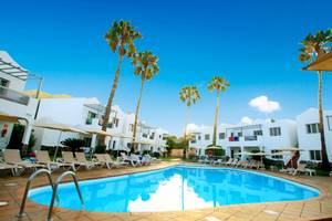 Poolbereich des Turbo Club Hotels mit weißen Gebäuden und Liegestühlen