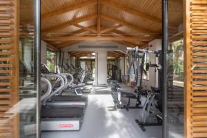Innenansicht des Fitnesscenters im Cretan Malia Park Hotel mit Laufbändern und Kraftgeräten.