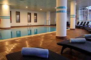 Innenpool im LABRANDA Ephesus Princess Hotel mit Lounge-Sesseln und Handtüchern.