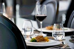 Speisetisch im Barcelo Raval Hotel mit Gerichten, Gläsern und Besteck.