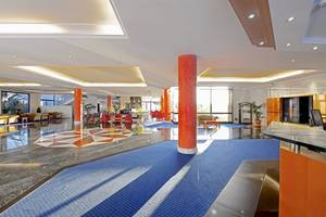 Lobby des Mirador Papagayo by LIVVO Hotels mit blauen Boden und roten Säulen.