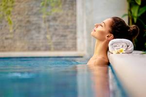 Frau genießt entspannt im Pool des El Dorado Royale Spa Resort