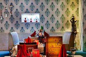 Italienisches Restaurant Tisch mit Servietten und Getränken, dekorative Wandmuster.