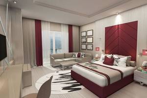 Elegantes Zimmer im Delphin BE Grand Resort mit modernem Design, hochwertigem Mobiliar und großem Fensterblick.