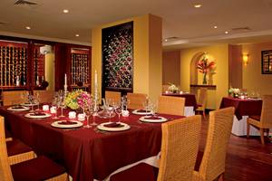 Weinkeller des Dreams Tulum Resort & Spa mit gedecktem Tisch und roten Tischdecken.