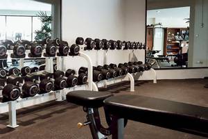 Fitnessstudio im Dewa Phuket Resort & Villas mit vielen Hanteln und Trainingsgeräten.