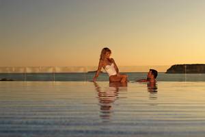 Ein Paar entspannt sich im Pool des Dubrovnik President Valamar Collection Hotels bei Sonnenuntergang.