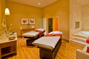 Spa-Behandlungsraum im Titanic Deluxe Lara Hotel mit zwei Massagetischen, einem Whirlpool und einem Sofa.