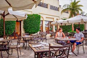 Paar sitzt draußen am Tisch im Steigenberger ALDAU Beach Hotel
