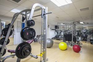 Fitnessraum im Lordos Beach Hotel mit Gewichtsgeräten und Fitnessbällen.