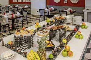 Buffet im Hotel AX The Palace mit verschiedenen Desserts, Früchten und Speisen.