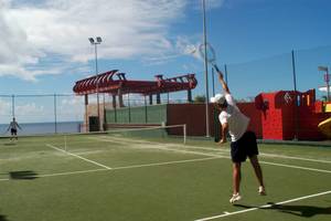 Tennisplatz im Gloria Palace Amadores Thalasso & Hotel mit zwei Spielern.