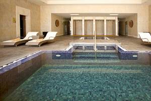 Innenpool im Barcelo Bavaro Palace mit Loungeliegen und Fliesenboden