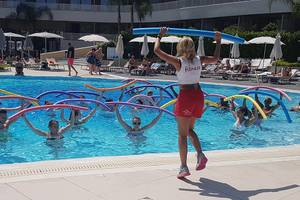 Gruppe von Teilnehmern, die Aqua-Fitness im Schwimmbad des Princess Andriana Resort & Spa durchführen.