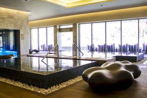 Wellnessbereich im Barcelo Maya Palace Hotel mit einem großen Pool und Loungemöbeln.