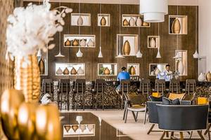 Innenansicht der Bar im Jaz Aquaviva Hotel mit Barhockern, Vasen und Dekorelementen.