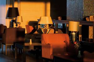 Sitzecke im Hotel Melas Lara mit mehreren Lampen und Tischen.