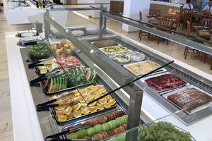 Buffet-Tisch im Aphrodite Beach Club Hotel mit verschiedenen Früchten und Desserts.