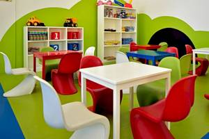 Kinderspielzimmer im Iberostar Costa Dorada Hotel mit bunten Möbeln und Spielzeug.