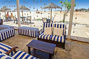Außenbereich des Oasis Belorizonte Hotels mit Blick auf den Strand und bestuhlten Terrassen.