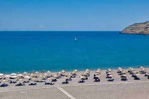 Strand des Lindos Bay Hotels mit vielen Sonnenschirmen und Liegen am Meer