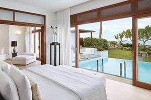Schlafzimmer im Amirandes Grecotel Boutique Resort mit Blick auf den Pool und das Meer