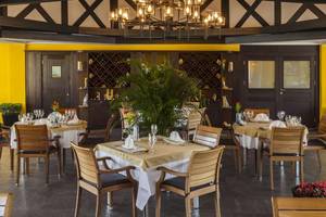 Innenansicht des Restaurants im Magic Life Belek mit gedeckten Tischen und gelben Wänden.