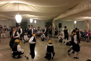 Gruppe von Tänzern im Sierra Silvana Hotel, einige spielen Instrumente, andere tanzen.