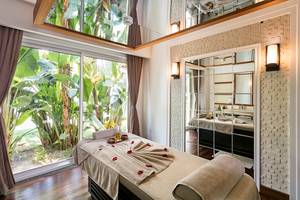 Massagebehandlung im Titanic Deluxe Golf Belek mit Blick auf Pflanzen und Spiegel.