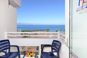 Balkon des Alexandre Hotel Troya mit Blick auf das Meer und eine Obstschale.