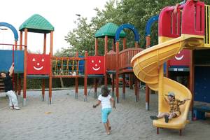 Kinder spielen auf dem Spielplatz im Candia Park Village