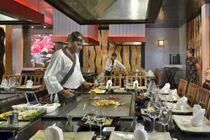 Japanisches Restaurant im Paradisus Princesa del Mar Resort & Spa mit Sushi-Küche und Gästen.