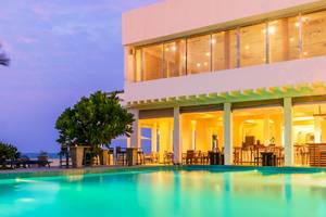 Jetwing Sea Hotel Pool bei Nacht mit Palmen und Meer im Hintergrund