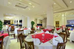Restaurant im Charmillion Club Aqua Park mit gedeckten Tischen und Stühlen.