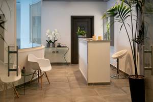 Lobby des Louis Paphos Breeze Hotels mit moderner Einrichtung und Pflanzen.