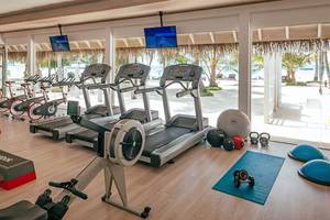 Fitnessstudio im Finolhu Baa Atoll Maldives mit Blick auf den Strand und Palmen.