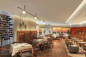 Innenansicht des JA Lake View Restaurants mit gedeckten Tischen, Stühlen und einer Weinflaschenwand.