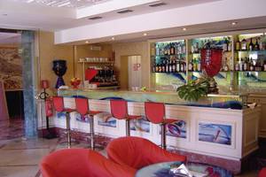 Rezeption des Principe Hotel Venedig mit roten Stühlen und blauem Tisch.