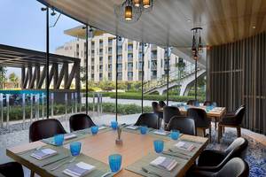 W Muscat Hotel Innenbereich mit Tisch und Stühlen, Blick auf den Garten